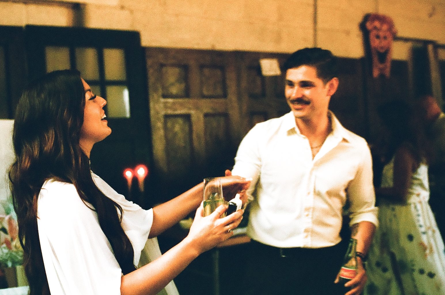 Alyssa and Giovanni toasting at a party