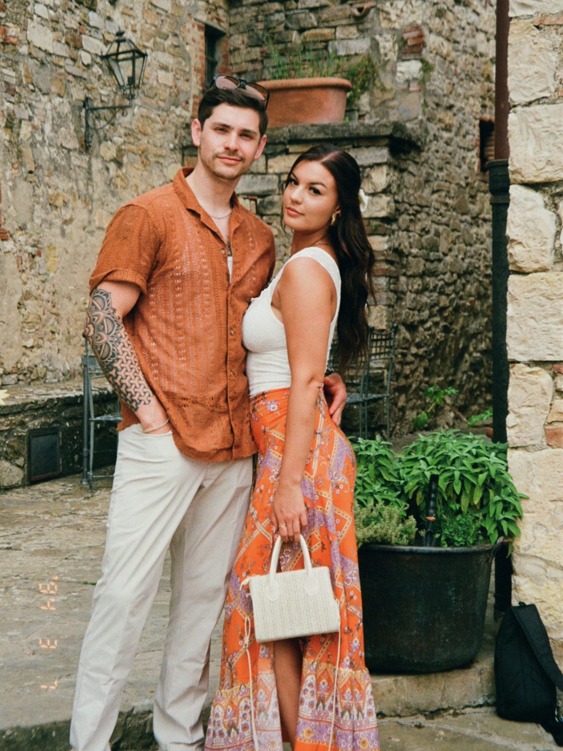 Alyssa and Giovanni in a Tuscan village courtyard